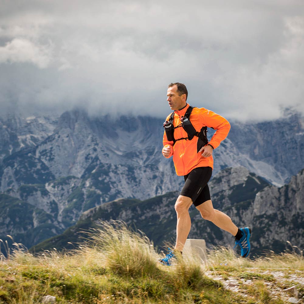 Running & Hiking Evaluation Man Running In High Alpine Terrain