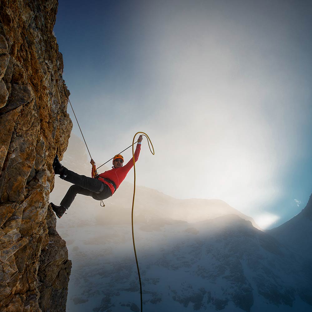 Visceral and Autonomic Treatment Climber Scaling Cliff with Dramatic Lighting